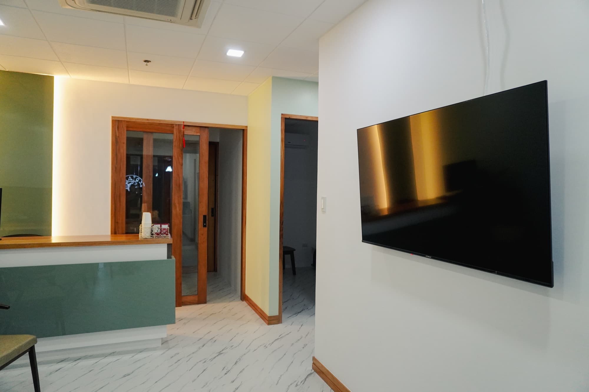 APV Healthcare reception area with wall-mounted display